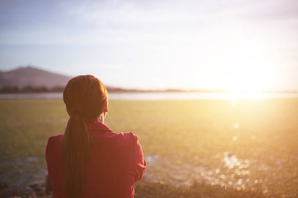 Young woman relaxation sitting looking the sun.