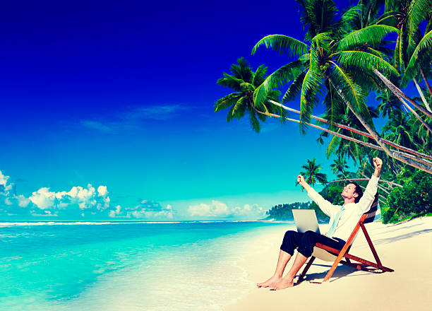 istock Businessman Relaxing Idyllic Palm Fringed Beach Concept 518782376