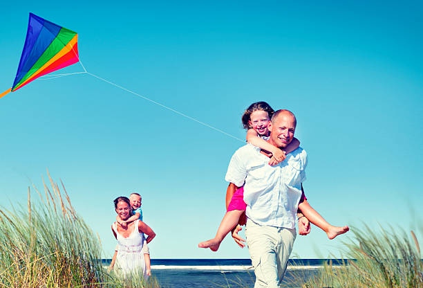 istock Cheerful Family Playing by the Beach Concept 518782610