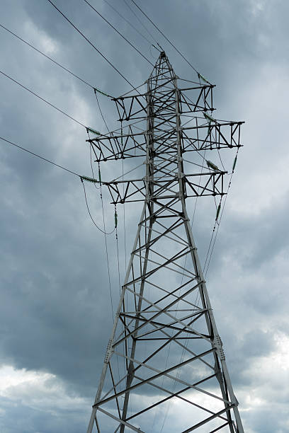 istock High voltage electricity pylons against rainy cloud. 518782784
