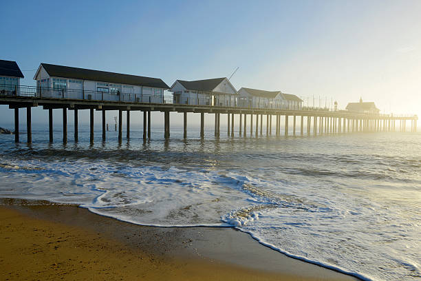 Southwold Pier Early light on Southwold Pier as the sea mist rolls back. southwold stock pictures, royalty-free photos & images