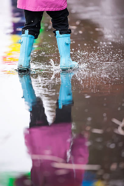 istock Girl Splashing In Puddle 518797839