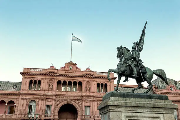 General Belgrano monument, designed by Albert Carriere-Belleuse in 1873, as a background, the Casa Rosada, seat of government of Argentina. Plaza de Mayo, Buenos Aires, Argentina.