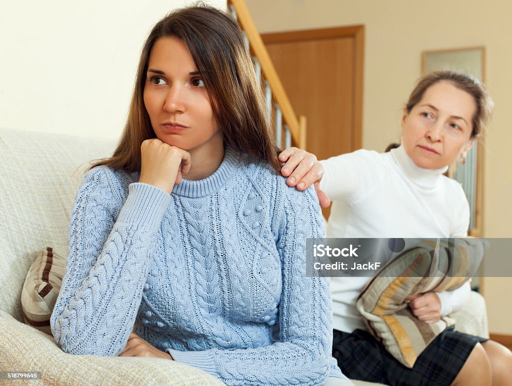 Mature woman tries propitiation her teen daughter Mature woman tries propitiation her teen daughter after quarrel. Focus on girl Adult Stock Photo