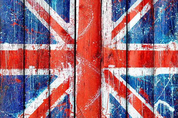 Photo of Painted wooden wall or fence with graffiti of British flag