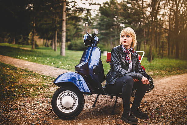 istock Young attractive woman is sitting on retro scooter 518799758