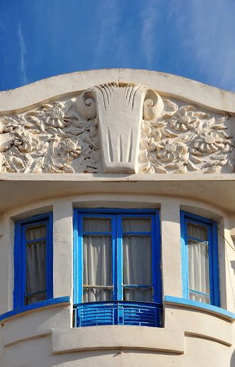 Béjaïa / Bougie, Kabylia, Algeria: art deco architecture - pediment with flowers - Frecnh colonial building on Boulevard Colonel Amirouche, forner Boulevard Biziou 
