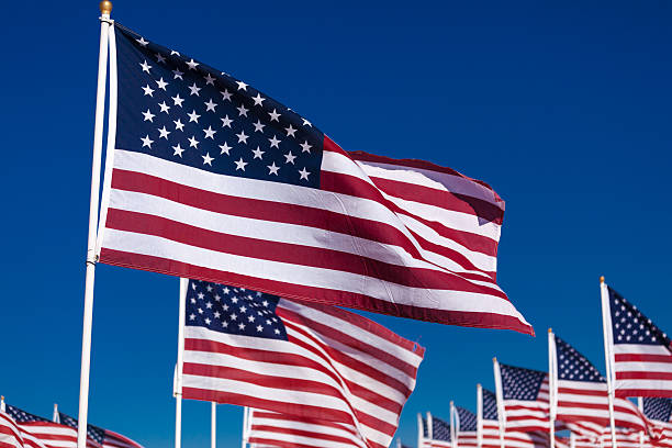 istock Display of American flags with a sky background 518800088
