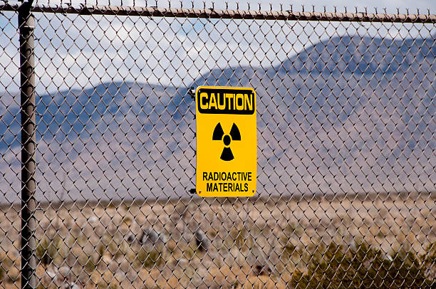 Socorro, New Mexico, USA  - April 2, 2016: Warning signs about radioactive materials were erected at what is now White Sands Missile Range following the detonation of the world's first atomic bomb in a remote area of south central New Mexico. The technology for a nuclear weapon was developed in extreme secrecy in what was known as the Manhattan Project. The test bomb, which was exploded July 16, 1945, proved that the concept would work and led to the dropping of two powerful atomic bombs on Japan -- helping to end World War II. Open houses are conducted free for the general public twice yearly at what is now known as the Trinity Site (ground zero), where photographs of various exhibits are permitted. The Trinity Site located about  35 miles southeast of of Socorro, New Mexico is a National Historic Landmark. 