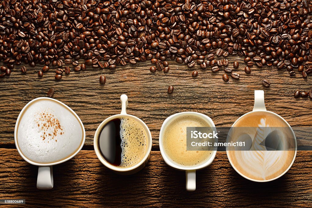 Cups of coffee Variety of cups of coffee and coffee beans on old wooden table Coffee Cup Stock Photo