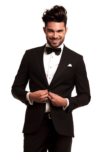 istock happy young elegant man in tuxedo buttoning his coat 518800823