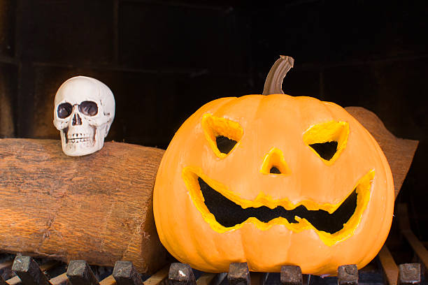 istock Halloween pumpkin in a fireplace 518802525