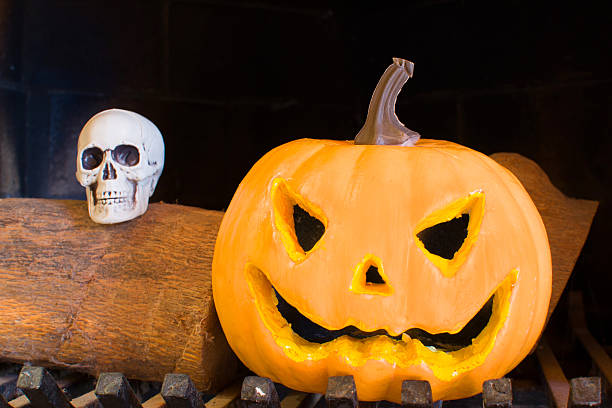 istock Halloween pumpkin in a fireplace 518802531