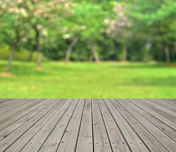 istock Green spring defocused abstract background and empty wooden platform 518803400