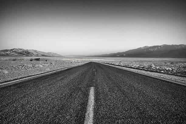 istock Desolate Road Through Death Valley in Black and White 518803968