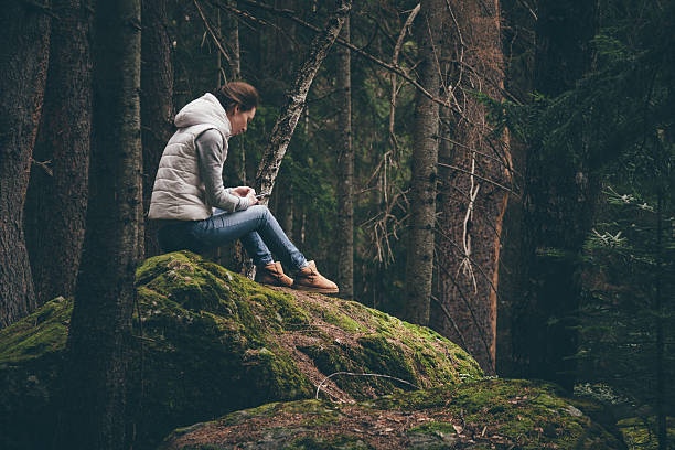 istock Female traveler uses a smartphone in a forest 518805022