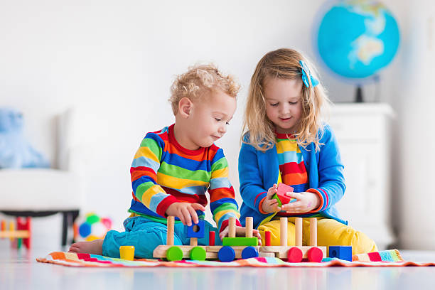 istock Kids playing with wooden toy train 518805672