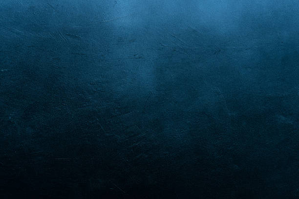 istock Old scratched and chapped painted dark blue wall 518805974