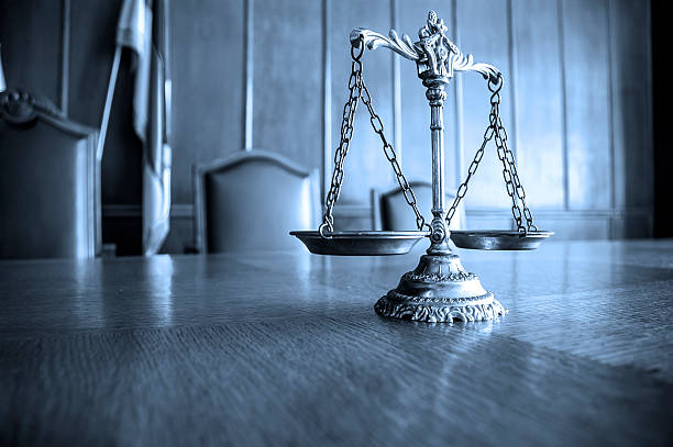 Decorative Scales of Justice Decorative Scales of Justice on the table. Focus on the scales, BLUE TONE equal arm balance photos stock pictures, royalty-free photos & images