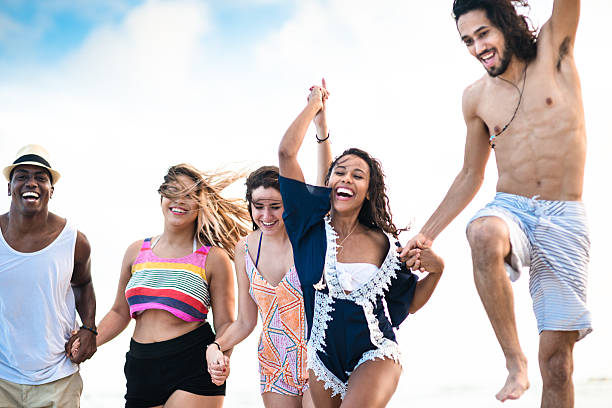 istock Group of friends running on the beach 518807574