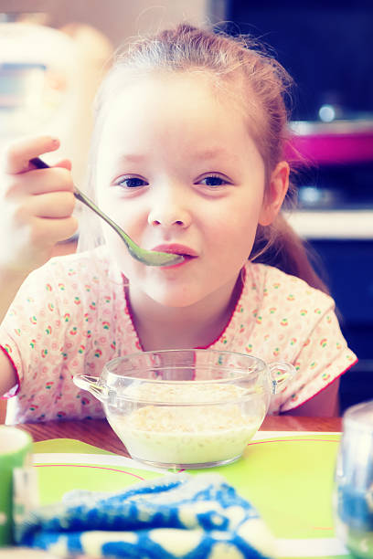 istock Girl having Breakfast in the kitchen 518814418