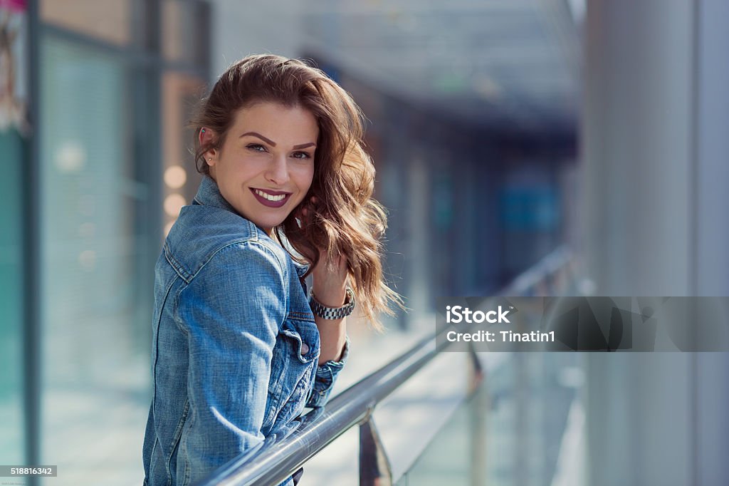 Woman in a shopping mall Pretty stylish woman walking in a shopping mall Adult Stock Photo