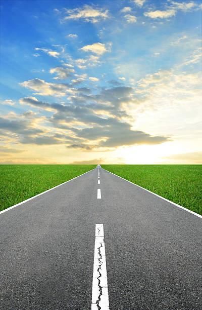istock asphalt road, green field and clouds on blue sky. 518816745
