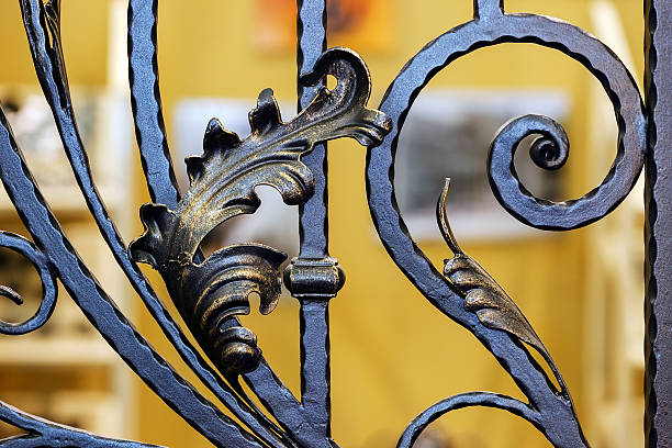 Wrought iron fence Details, structure and ornaments of wrought iron fence with gate wrought iron stock pictures, royalty-free photos & images