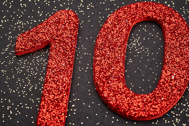 istock Number ten red color over a black background. Anniversary 518818534