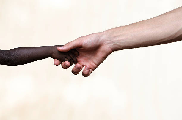 istock Peace on Earth: White Man Holding Black Child Symbols 518819717
