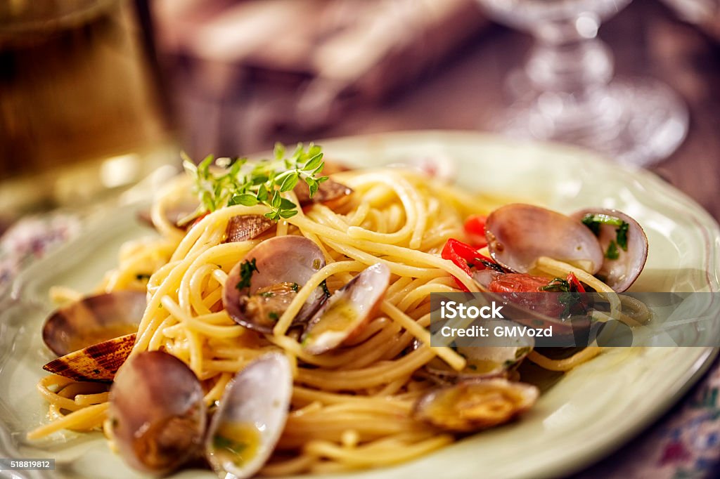 Delicious Spaghetti alla Vongole Served on a Plate Delicious homemade Spaghetti Vongole with garlic, chili, parsley and white wine served on a plate Italian Food Stock Photo