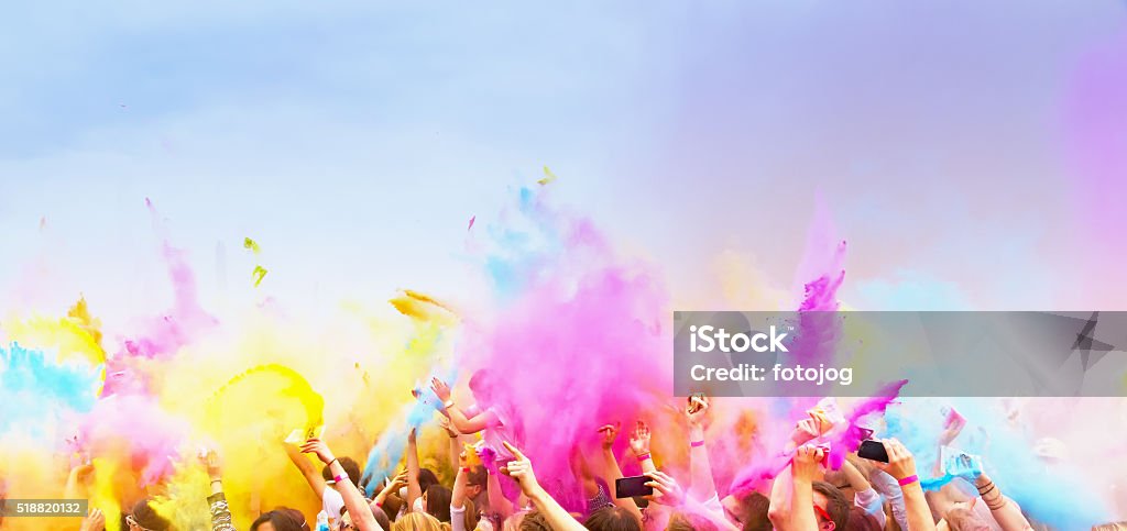 Celebrants dancing during the color Holi Festival Happy , celebrants with smart phones dancing during the color Holi Festival Music Festival Stock Photo