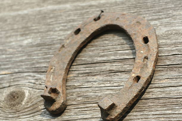 istock Rusty horseshoes on a wooden background. 518826862