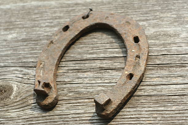 istock Rusty horseshoes on a wooden background. 518826896