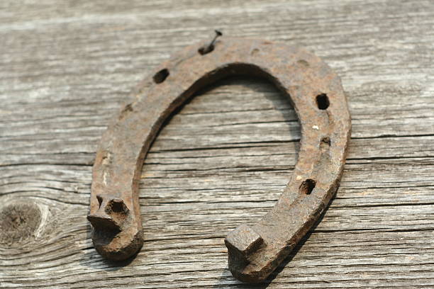 istock Rusty horseshoes on a wooden background. 518826928