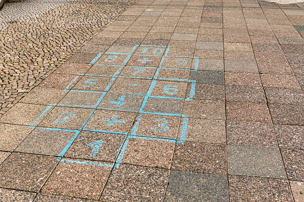 istock playing hopscotch in the street 518826986
