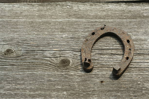 istock Rusty horseshoes on a wooden background. 518826990