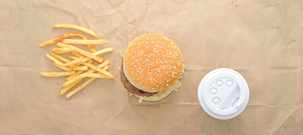 istock Burger, fries and coffee in plastic Cup on paper background. 518827966