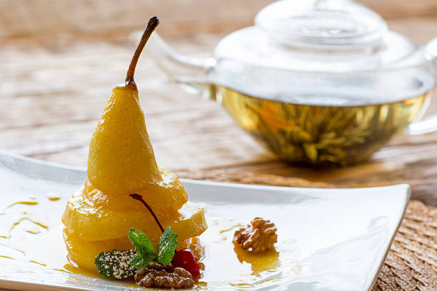 istock Pear in orange juice with herbal tea 518828090
