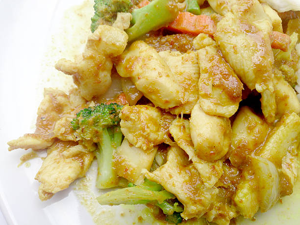istock Green curry fried Vegetable with chicken on dish,Thai Food 518828290