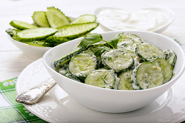 Fresh cucumber salad with yogurt and herbs. stock photo