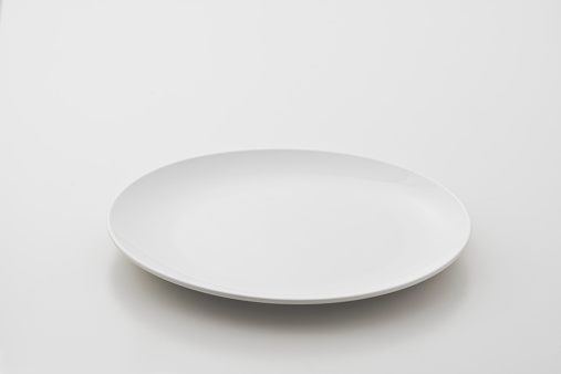 Circular porcelain plate on white background