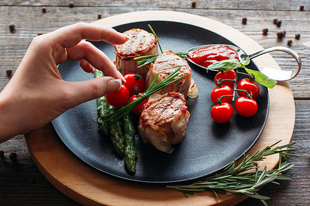 istock Food  decorating. Chef decorating a pork dish. 518831474