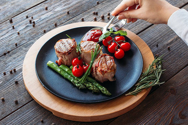 istock Food  cooking. Chef decorating a pork dish. 518831934