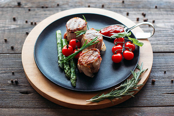 istock Grilled pork with vegetables on black plate 518832118