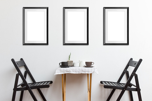 Three mock-up poster frame in coffee corner interior background.