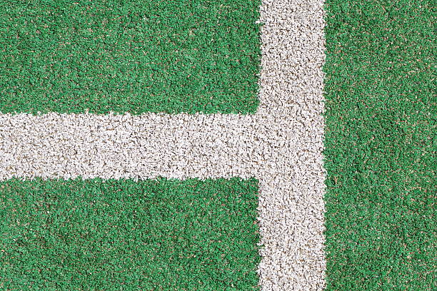 istock White stripe on the green soccer field from top view 518832413