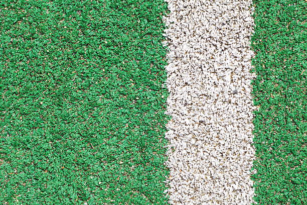 istock White stripe on the green soccer field from top view 518832417