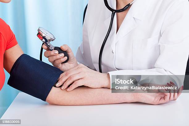 Doctor Doing Professional Pressure Examine Stock Photo - Download Image Now - Adult, Apron, Blood