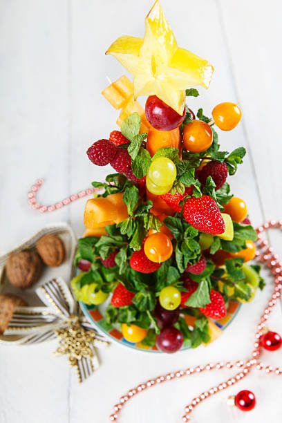 istock Creative fruit Christmas tree with different berries, fruits and 518833689
